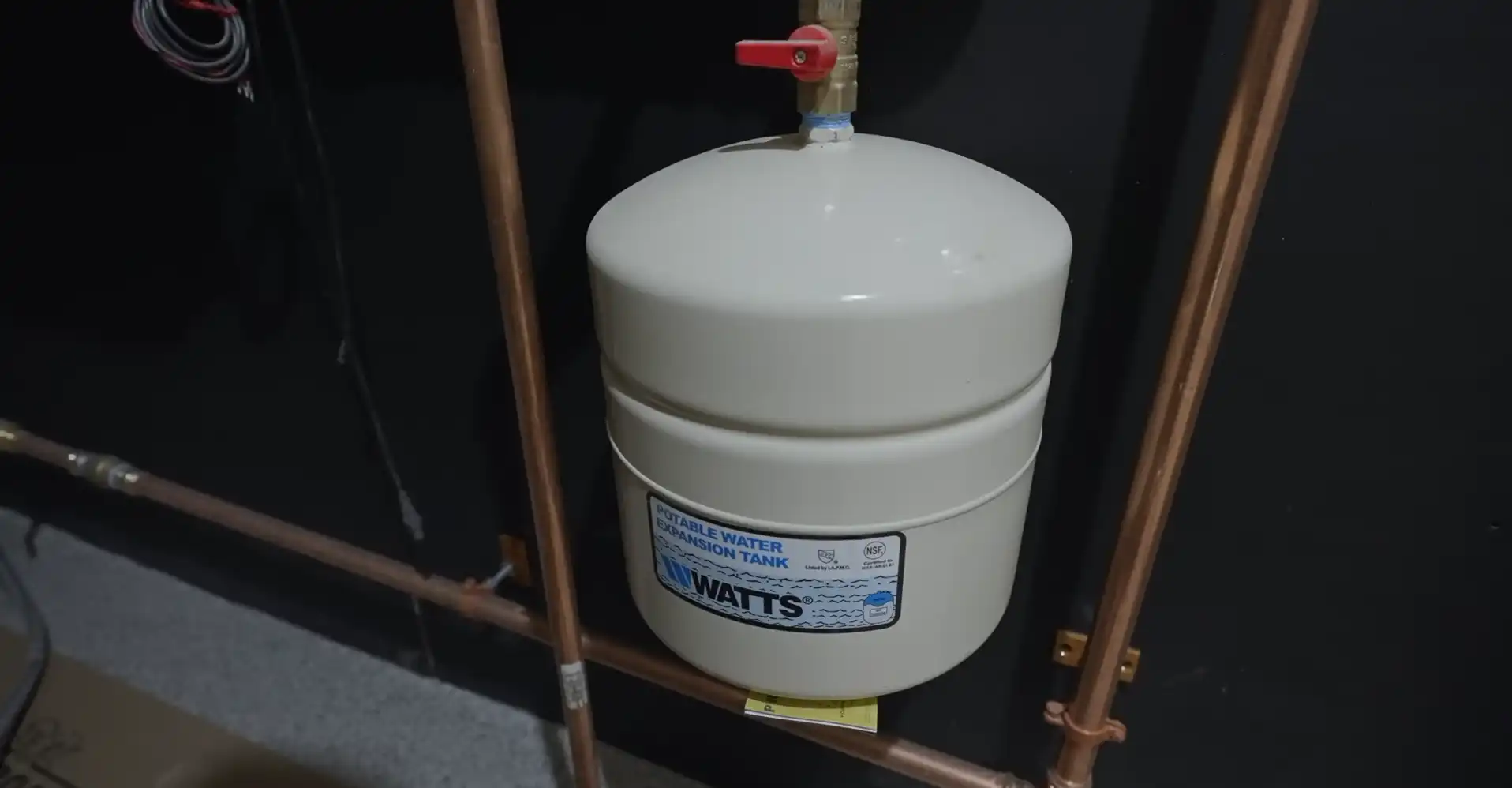 New elevated tankless water heater installed in a Yuma garage